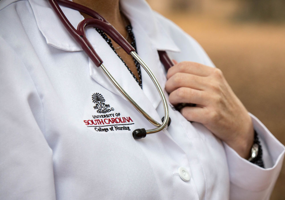a nursing student in a white coat with stethascope
