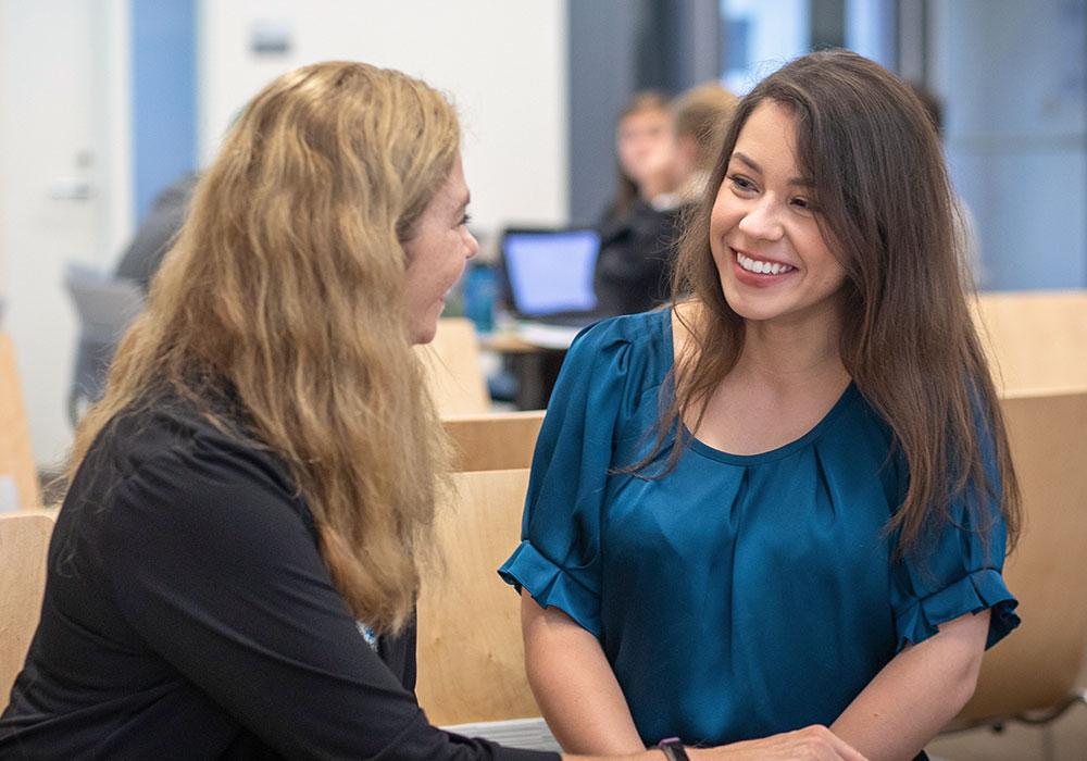 Two people talking together.