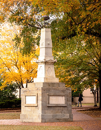 Maxcy Monument on a pretty fall day with yellowing trees in the background.