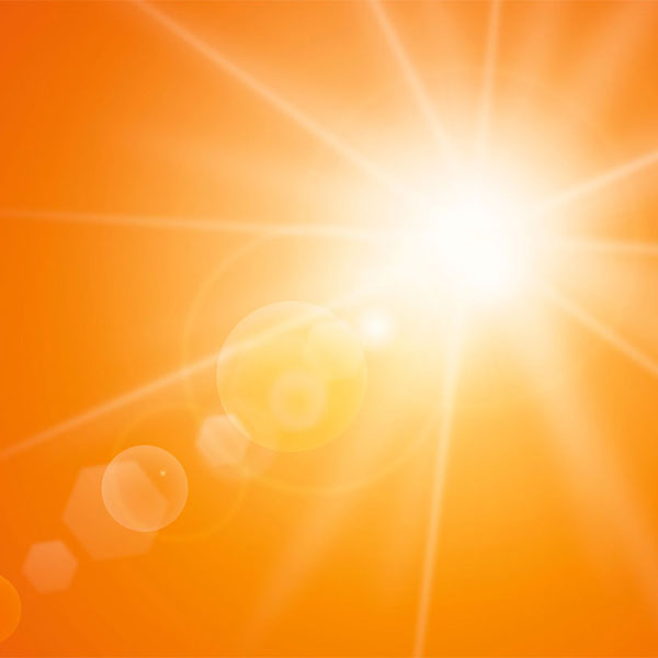 Orange background with sun and a lens flare. 