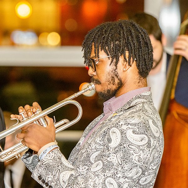 Student playing a trumpet at a jazz performance.