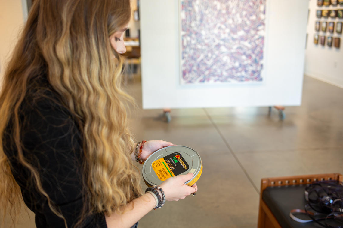 Madeline Walshe examines a roll of film at Stormwater Studios.