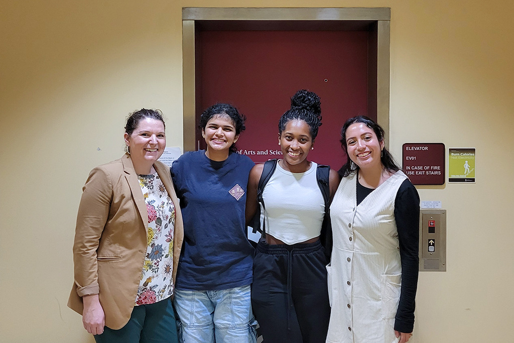 Four women pose for group photo.
