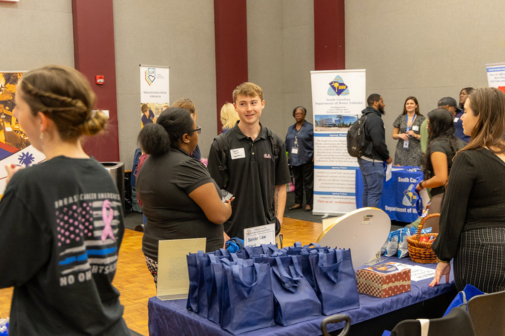Students and employers talk together at a career fair held in the Russell House ballroom.