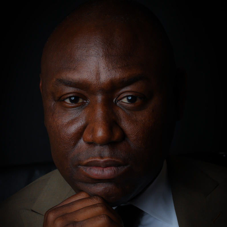 Benjamin Crump is looking at the camera against a black background