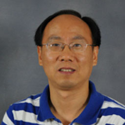 photo of a man with blue and white striped shirt on and glasses