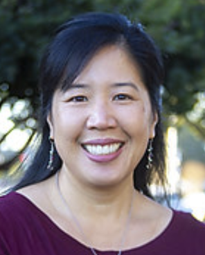 Christine Nordahl, an Asian woman with dark hair and bangs, smiles at the camera