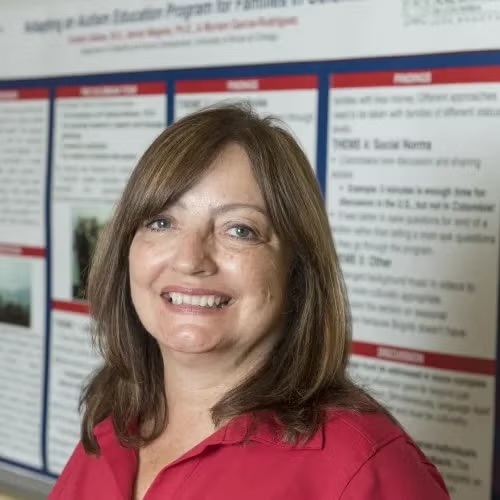 Dr. Magaña, a Latina woman with shoulder length brown hair, smiles at the camera