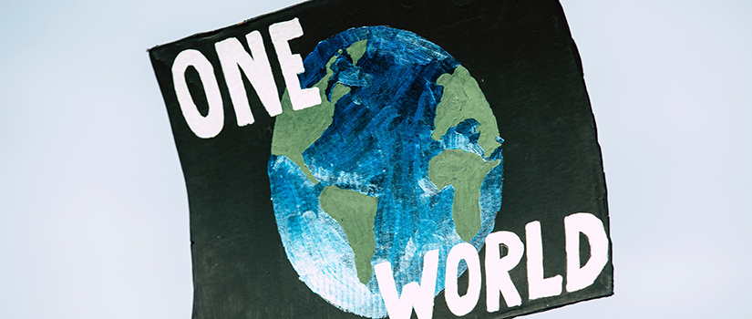 image of a globe on a banner that reads "one world"