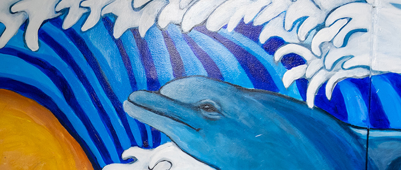 mural featuring yellows and blues and a dolphin