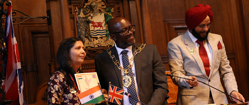 A woman holds the Hind Rattan Award beside the Lord Mayor of Oxford during an award ceremony in Oxford, United Kingdom.