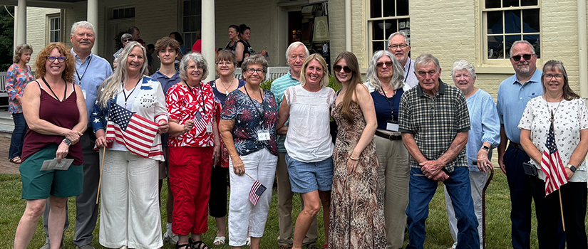 group of people posting with american flag.  