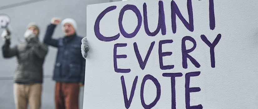 People with sign that reads count every vote.