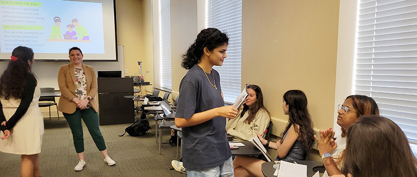 Bhavani Tuppale introduces herself to a peer during a University 401 class.
