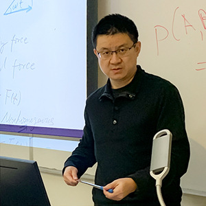 Photo of Yi Sun teaching in class.