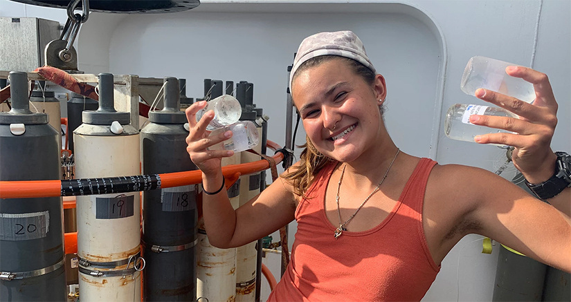Maggie Gaspar holding water samples and smiling