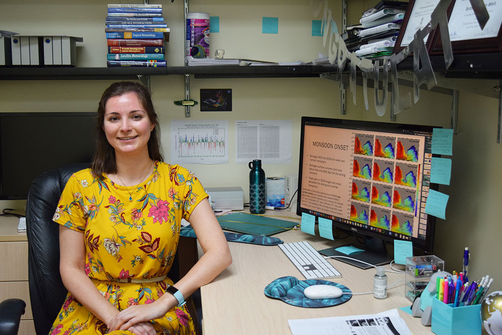 Heather Roman-Stork sits in her office. Her computer monitor displays satellite images showing the movement of freshwater pools in the ocean