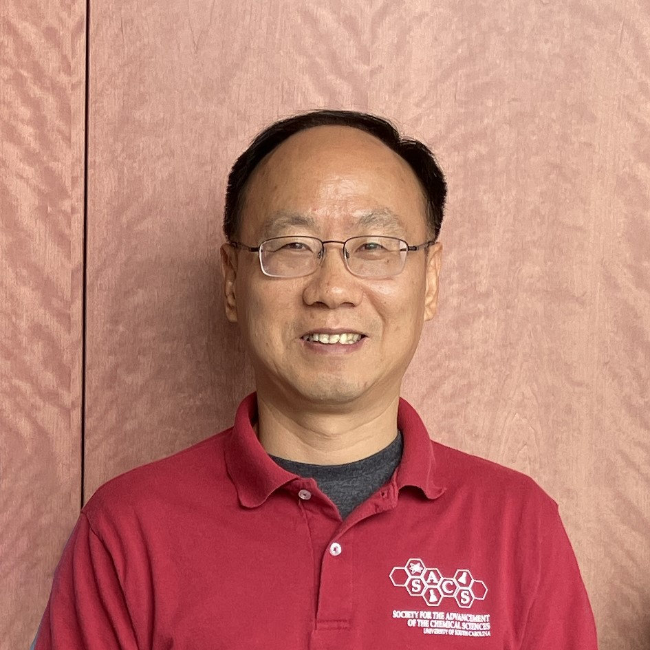 Photo of Dr. Tang wearing a red shirt. 