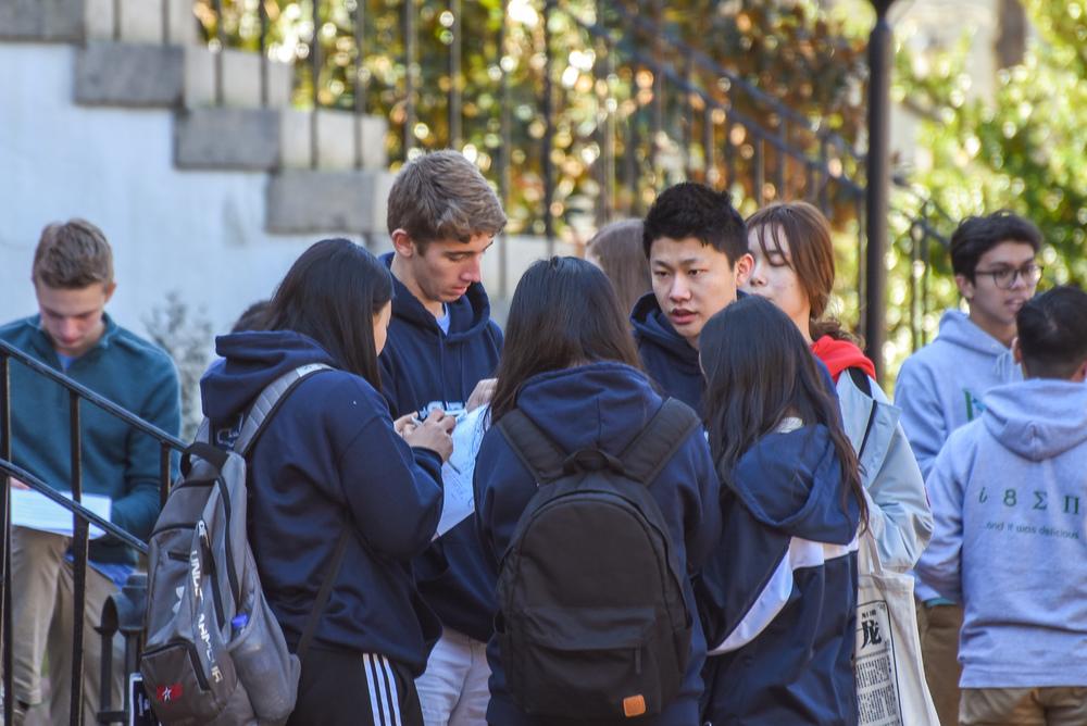 Students discussing a math problem in the park