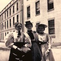 three women in front of a building