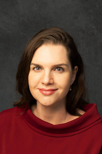 woman with black jacket on and dark hair 