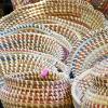 Display table of colorfully woven baskets
