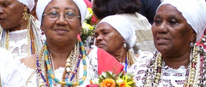 ladies wearing colorful beads and white head scarves