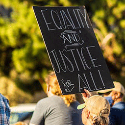 people protesting with justice for all sign