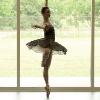 Alumna Olivia Waldrop rehearses in front of one of our studios' picturesque windows.