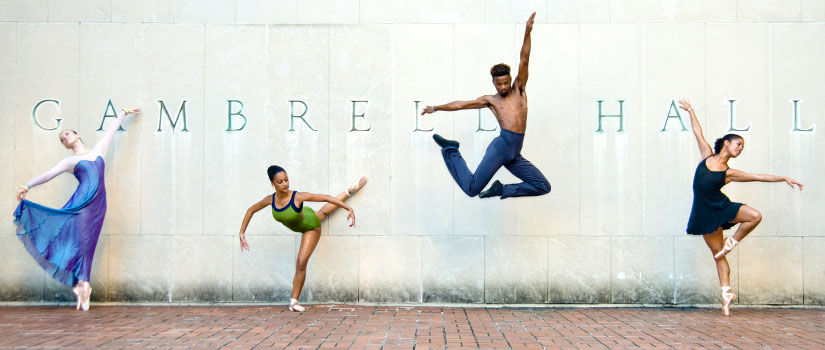 Dancers in various poses in front of Gambrell Hall