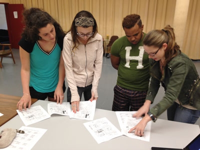 Media Arts student Emily Shea (right) explains the order of manga panels during auditions to Theatre students (from left) Kelsie Hensley, Beth McNamara, and Leroy Kelly.