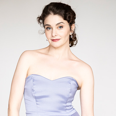 Portrait of Kathryn Morgan in a lavender strapless dress.