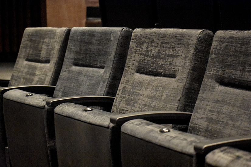 Close-up photo of new seats with black plush upholstery in Longstreet Theatre.