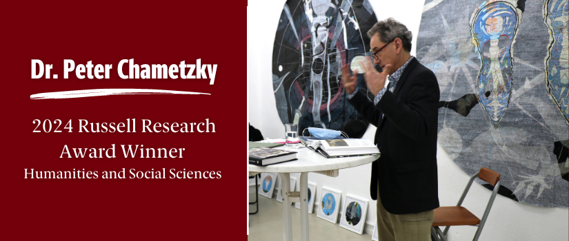 Banner image with Professor Chametzky giving a lecture. There is a garnet background on the left side with text that reads "Dr. Peter Chametzky 2024 Russell Research Award Winner - Humanities and Social Sciences"
