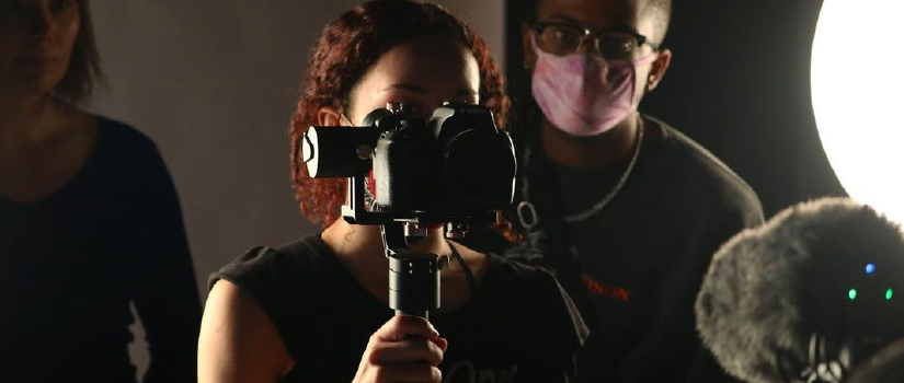 Woman using equipment on a film set