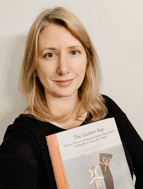 A photograph of Professor Wangwright holding her new book, The Golden Key.