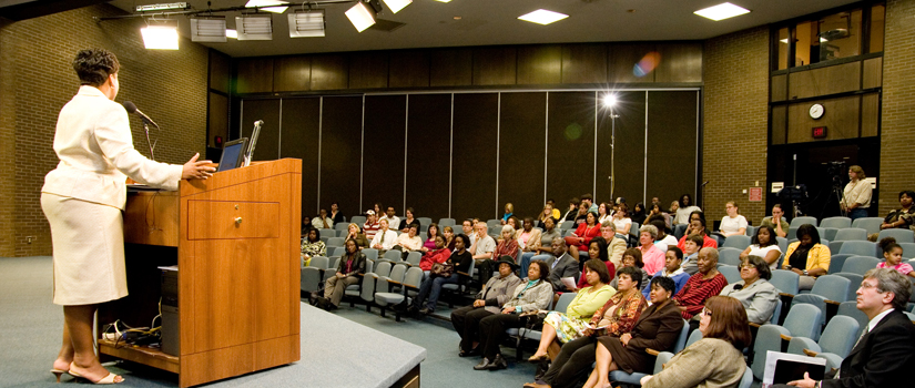 Women presenting at a podium