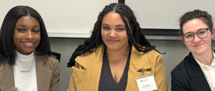 three women smiling at conference