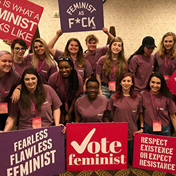 Photo of students with signs that represent feminism