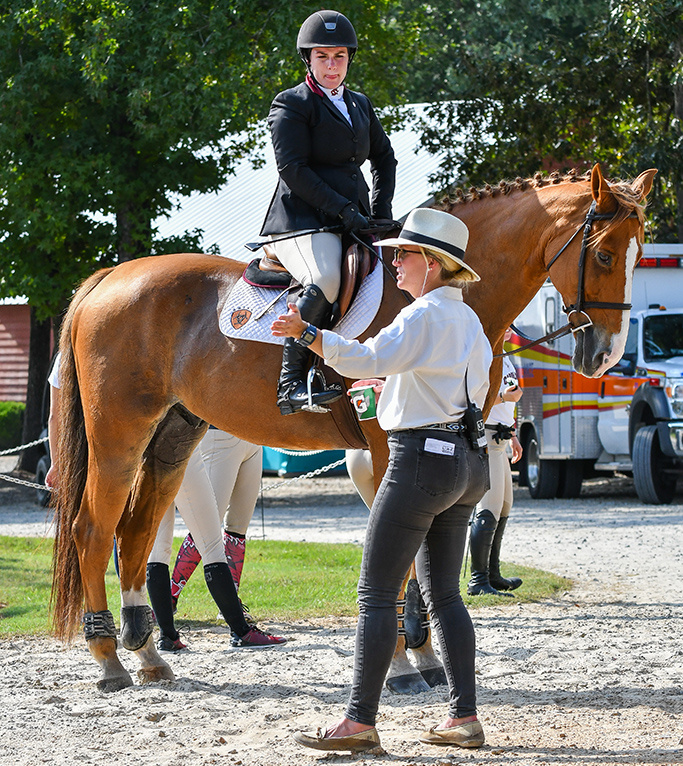 Assistant head coach Kristen Terebesi works with an equestrian student.