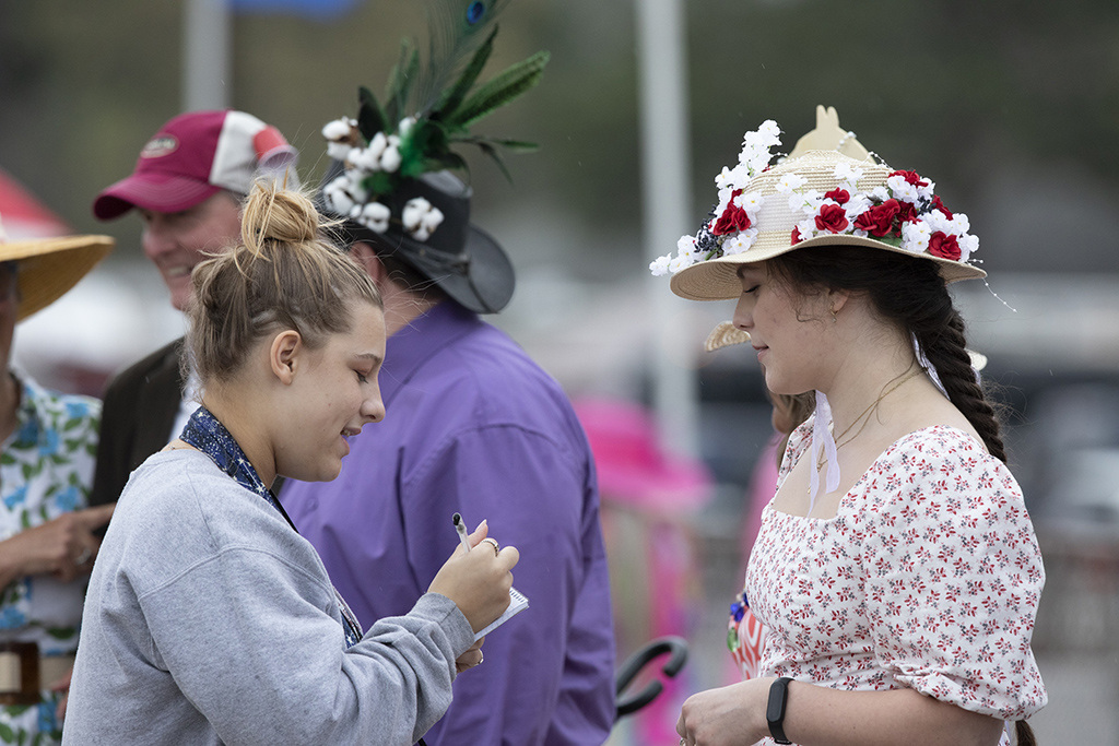 Student photographer Rachel Barkoff interviews Laura Smith about her participation in the hat contest at the 88th running of the Carolina Cup.