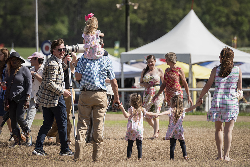 Student photographer Aidan Peck, left, catches up to interview a family he photographed at the 88th Running of the Carolina Cup on Saturday, April 1, 2023, in Camden, S.C. 