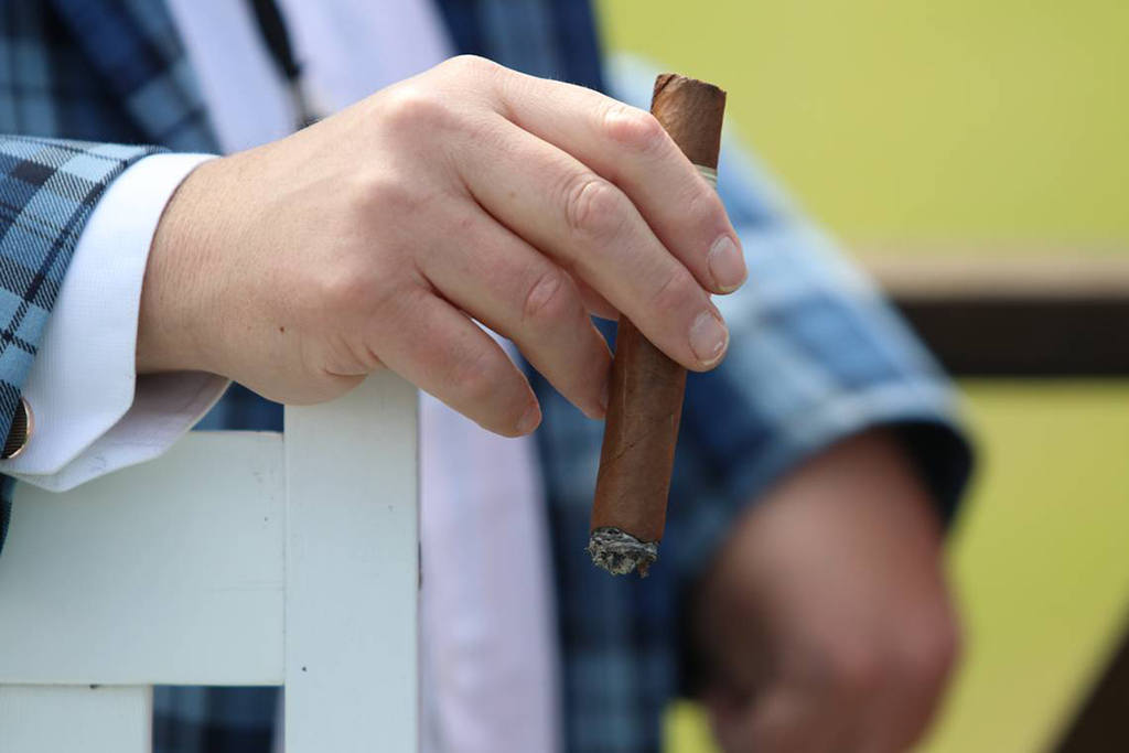 Robert Cahaly of Leesville,South Carolina, enjoys a cigar at the Mullikin private tent at the Carolina Cup on April 1, 2023. Photo by NOAH VIOLETTE