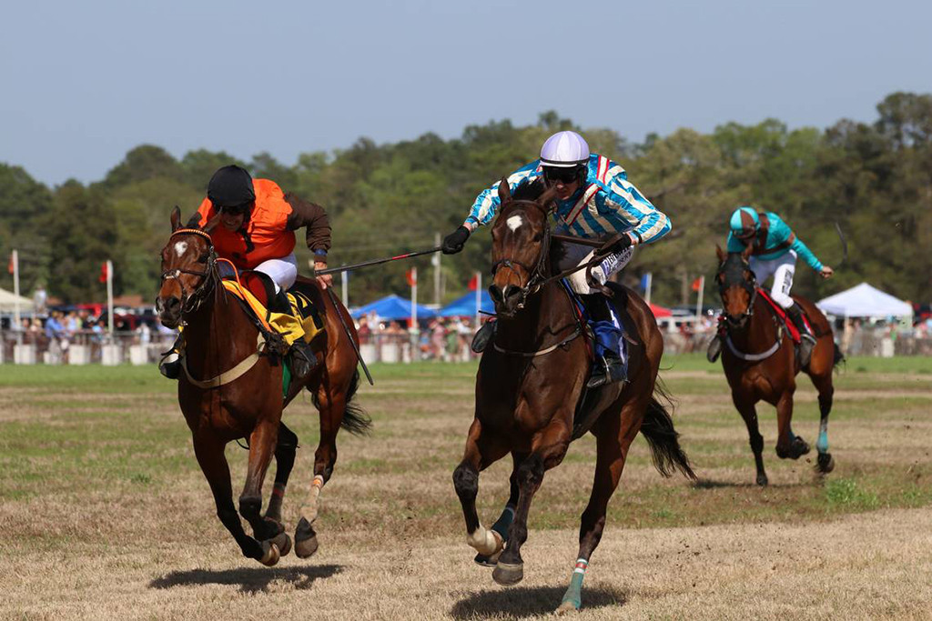 In the final stretch, jockey David England prepares to overtake Graham Watters in order to win the race in the 88th Running of the Carolina Cup on April 1, 2023. Photo by TORI WRIGHT