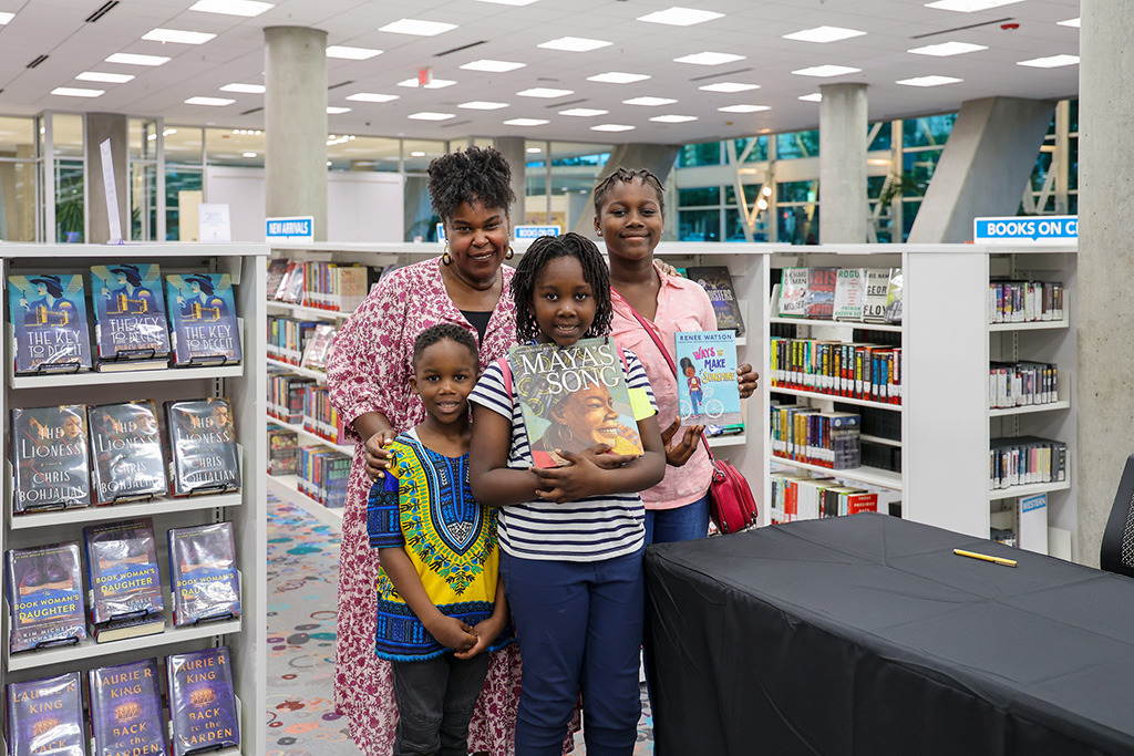 Fifth grader Asale Mfomboutmoun and her siblings with Renée Watson.