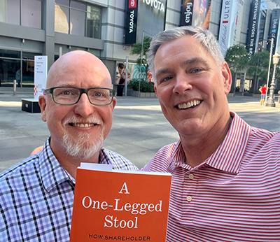 Ed Chambliss and the dean holding a book