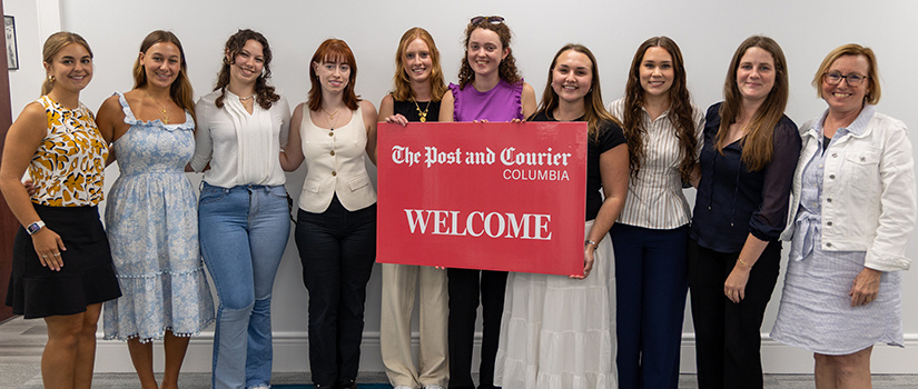 post and courier internships posing with a welcome sign