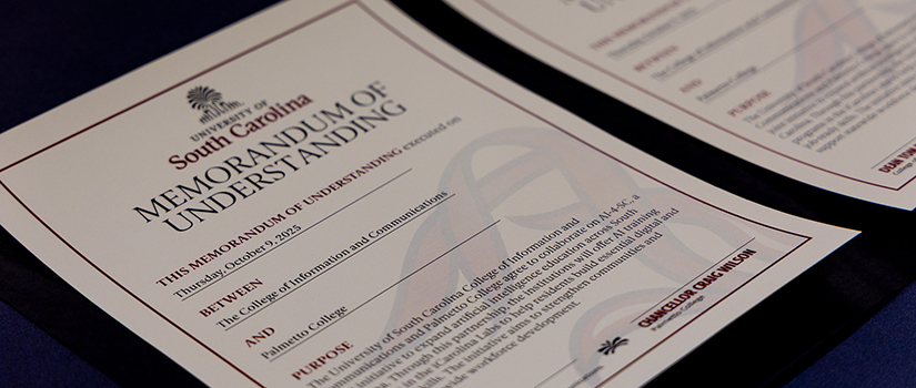 Craig Wilson and Tom Reichert holding the Memorandum of Understanding