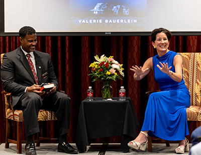 Damion Waymer and Valerie Bauerlein laughing on stage