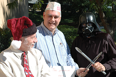 Bierbauer and Doug Fisher cooking hotdogs at the Halloweiner
